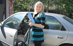 Girl standing by car