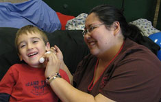 Boy and therapist laughing